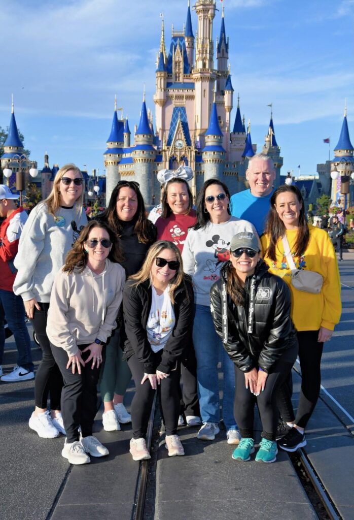 A group of people standing in front of a castle.